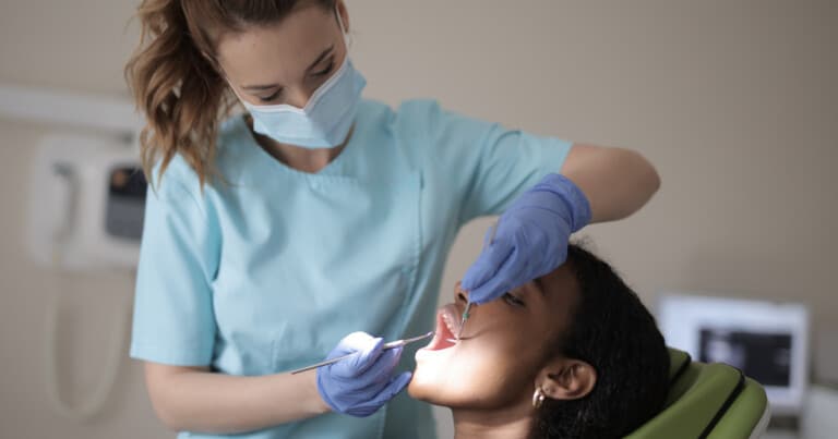 This is a picture of a dentist examining a patient's teeth.